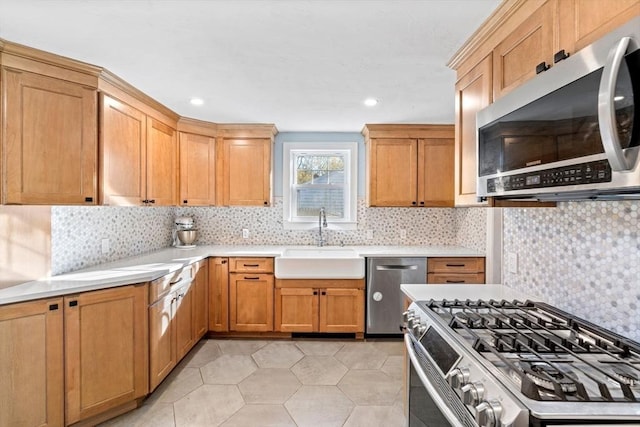 12 Babson St, Wakefield, MA 01880 - kitchen featuring appliances with stainless steel finishes, light countertops, tasteful backsplash, and recessed lighting