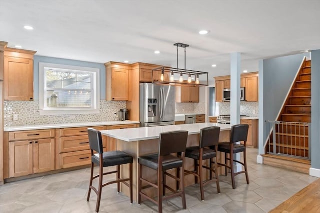 12 Babson St, Wakefield, MA 01880 - kitchen featuring stainless steel appliances, recessed lighting, light countertops, a center island, and backsplash