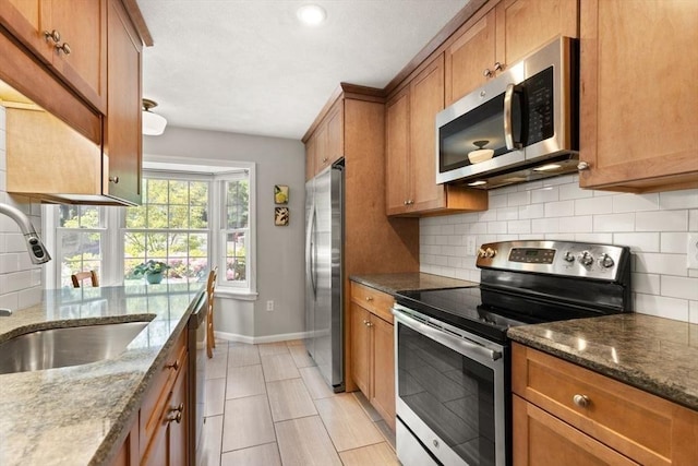 25 Valiant Way Unit 25, Salem, MA 01970 - kitchen featuring appliances with stainless steel finishes, a sink, brown cabinets, baseboards, and recessed lighting