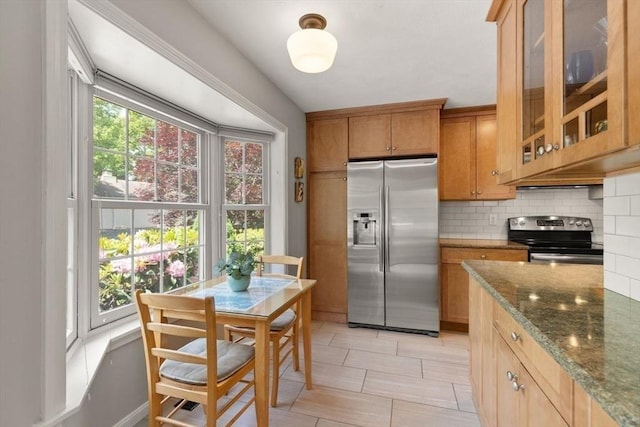 25 Valiant Way Unit 25, Salem, MA 01970 - kitchen with stainless steel fridge with ice dispenser, electric range oven, decorative backsplash, dark stone counters, and glass insert cabinets