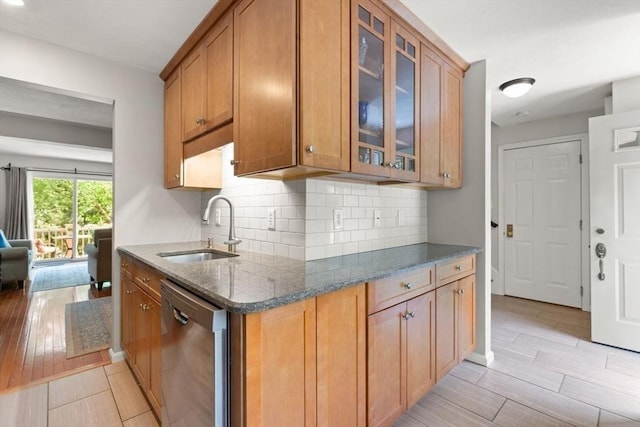 25 Valiant Way Unit 25, Salem, MA 01970 - kitchen featuring dishwasher, a sink, backsplash, light wood-style floors, and dark stone countertops