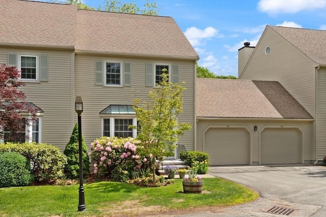 25 Valiant Way Unit 25, Salem, MA 01970 - view of front facade featuring an attached garage, driveway, a shingled roof, and a front yard