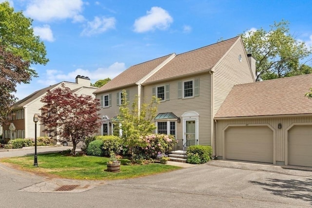 25 Valiant Way Unit 25, Salem, MA 01970 - townhome / multi-family property with an attached garage, a chimney, asphalt driveway, a shingled roof, and a front lawn