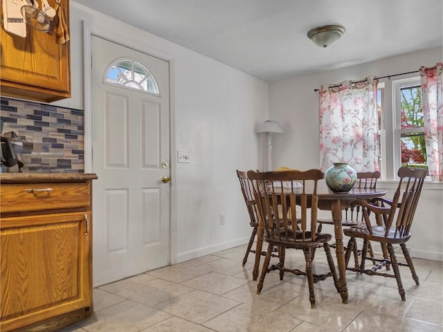 dining area with a healthy amount of sunlight, baseboards, and light tile patterned floors