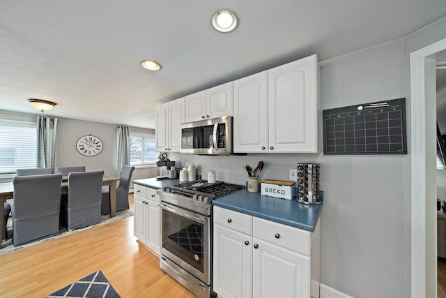 kitchen with recessed lighting, white cabinetry, appliances with stainless steel finishes, and dark countertops