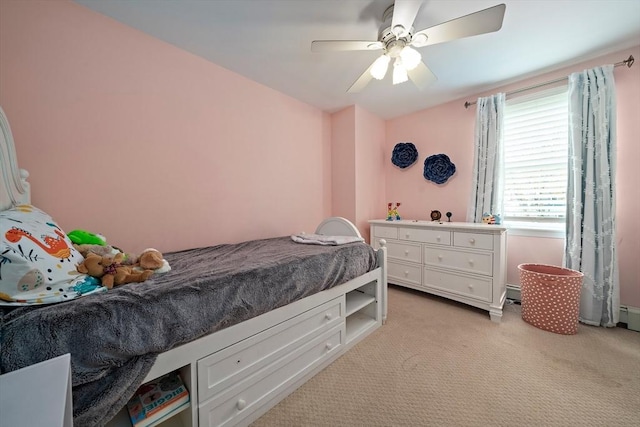 bedroom with light colored carpet and a ceiling fan