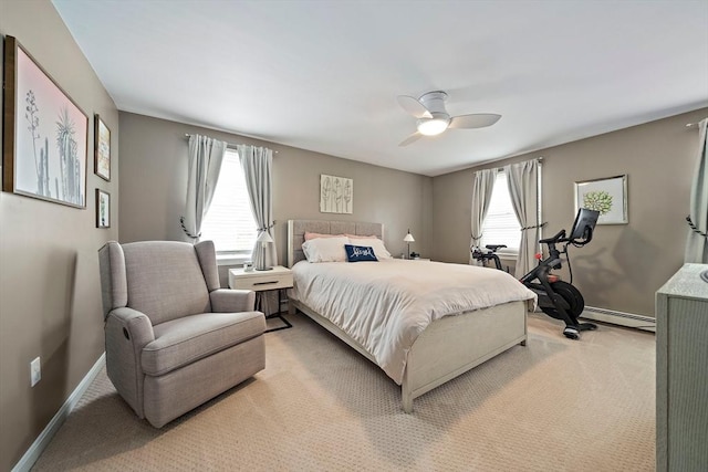 bedroom with baseboards, ceiling fan, baseboard heating, and light carpet