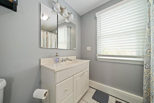 bathroom with tile patterned flooring, vanity, toilet, baseboards, and baseboard heating