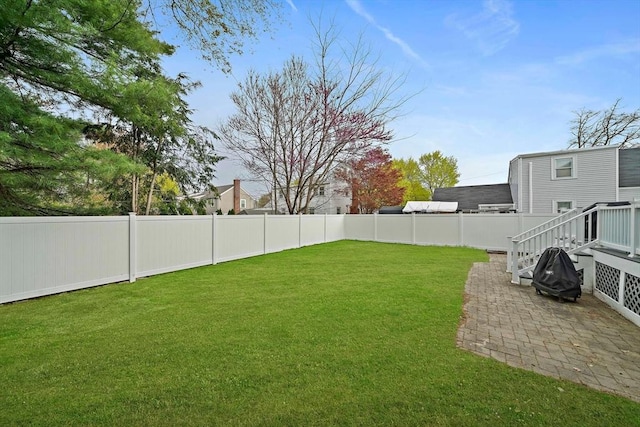 view of yard featuring a fenced backyard and a patio area