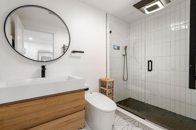 bathroom with toilet, tile patterned floors, a shower with shower door, and vanity