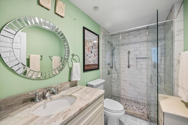 full bathroom with marble finish floor, vanity, a shower stall, and toilet