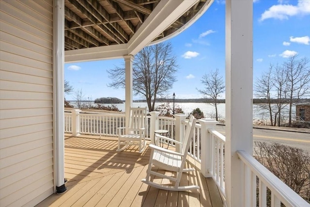 wooden terrace featuring a water view