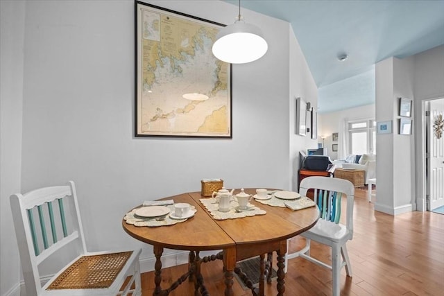 dining area featuring wood finished floors and baseboards