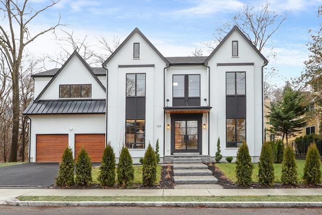 modern farmhouse style home featuring a garage