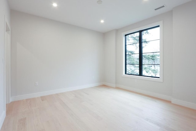 unfurnished room with light hardwood / wood-style floors