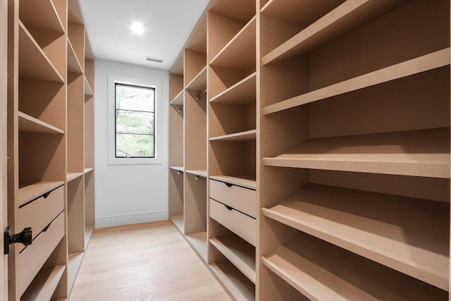 spacious closet with light hardwood / wood-style flooring