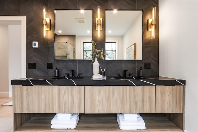 kitchen with sink, light brown cabinets, and backsplash