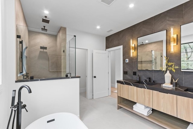 bathroom with a shower with shower door and vanity