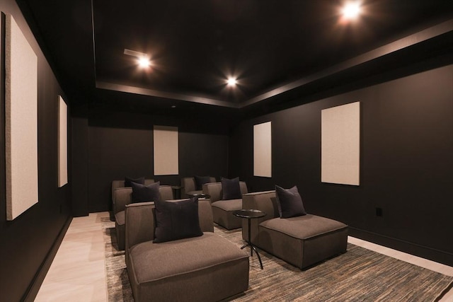 home theater featuring a raised ceiling