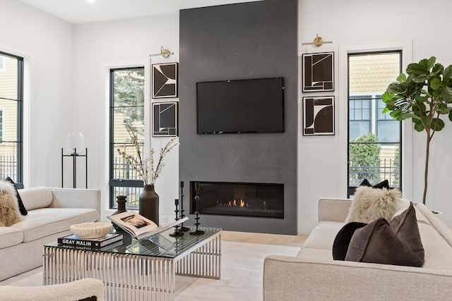 living room with plenty of natural light and a fireplace