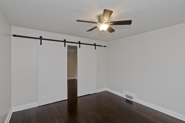 24 City View Ave, West Springfield, MA 01089 - unfurnished bedroom with a barn door, dark wood-type flooring, and ceiling fan