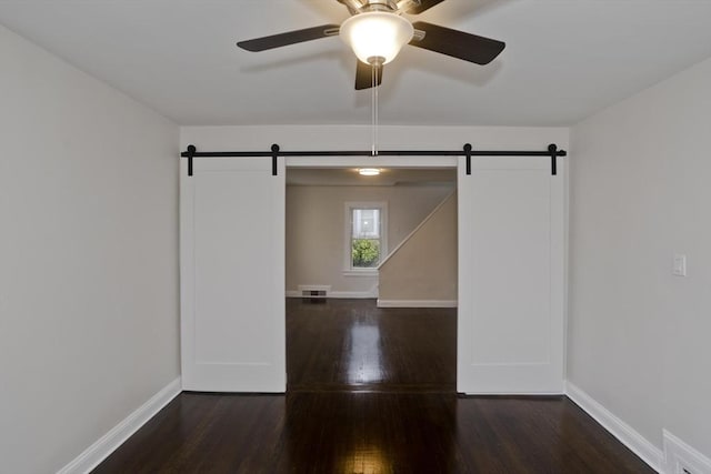 24 City View Ave, West Springfield, MA 01089 - empty room with a barn door, wood finished floors, and a ceiling fan