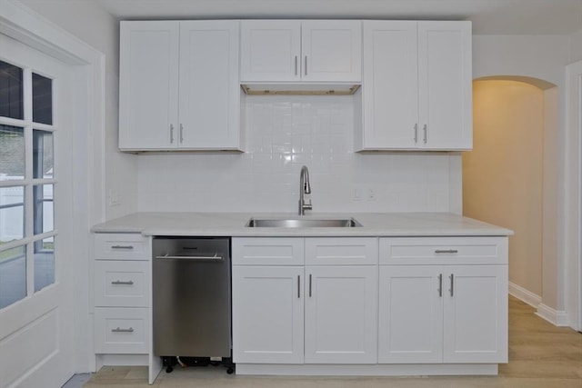 24 City View Ave, West Springfield, MA 01089 - kitchen featuring tasteful backsplash, light countertops, white cabinets, and arched walkways
