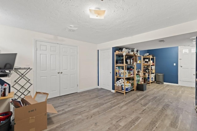 212 Washington St Unit 212, Canton, MA 02021 - home office featuring a textured ceiling, wood finished floors, and baseboards