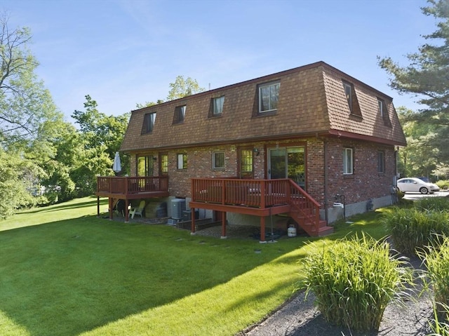 212 Washington St Unit 212, Canton, MA 02021 - back of property featuring a wooden deck, brick siding, a yard, and mansard roof