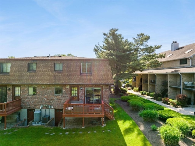 212 Washington St Unit 212, Canton, MA 02021 - rear view of house with a deck, roof with shingles, a yard, brick siding, and mansard roof