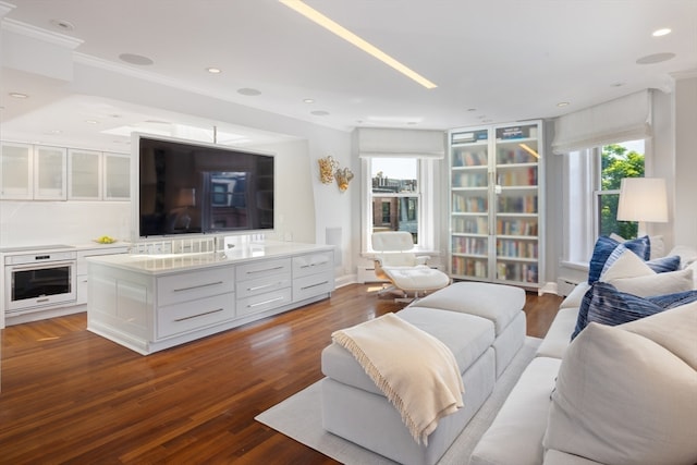 living room featuring ornamental molding and dark wood-type flooring