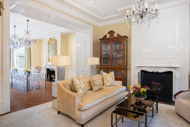 living room featuring crown molding, a premium fireplace, a chandelier, and light parquet flooring