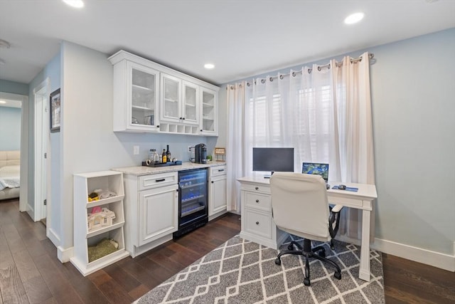 office with dark wood-type flooring, recessed lighting, wine cooler, baseboards, and a dry bar