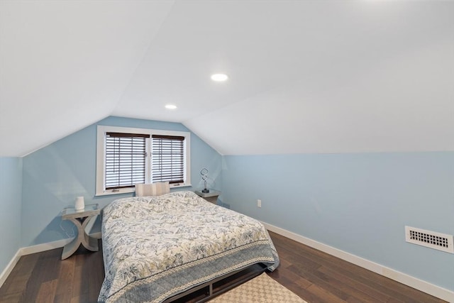 bedroom with vaulted ceiling, visible vents, baseboards, and dark wood-style flooring