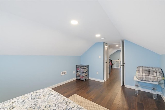 bedroom featuring visible vents, baseboards, vaulted ceiling, recessed lighting, and wood finished floors