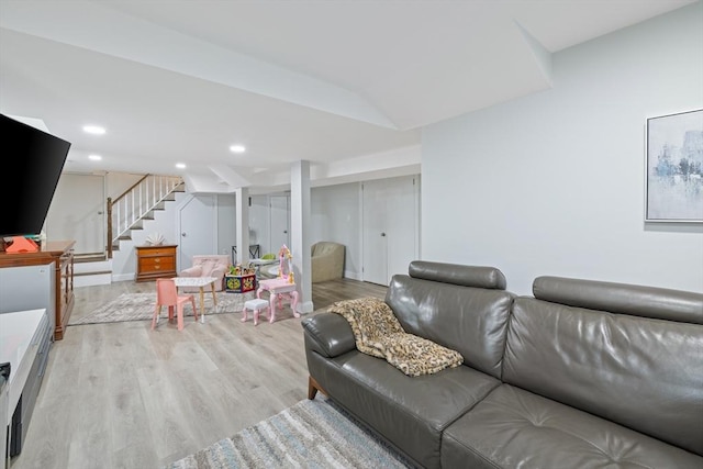 living area with stairs, recessed lighting, and light wood-style floors