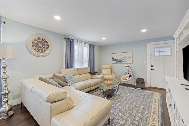 living room with recessed lighting, baseboards, and dark wood-type flooring