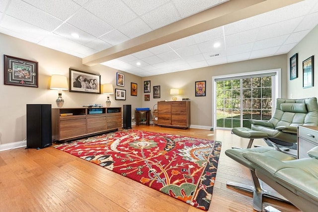 interior space featuring a paneled ceiling, recessed lighting, baseboards, light wood-type flooring, and visible vents