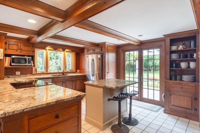 188 Main St, Wilbraham, MA 01095 - kitchen with appliances with stainless steel finishes, brown cabinetry, beamed ceiling, ornamental molding, and light stone counters