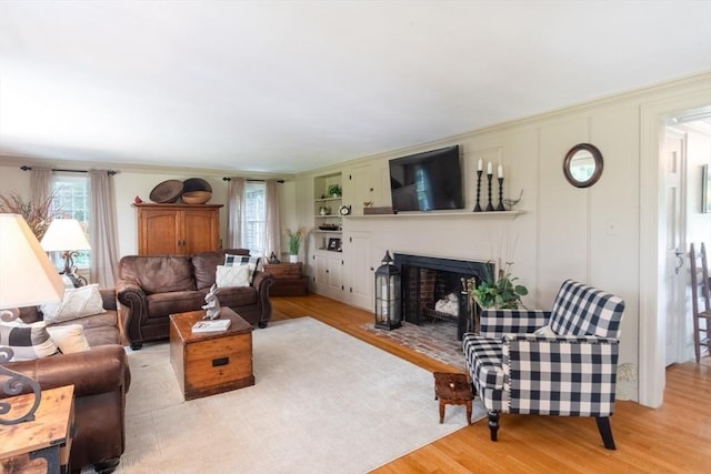188 Main St, Wilbraham, MA 01095 - living room with wood finished floors, a fireplace with flush hearth, and ornamental molding