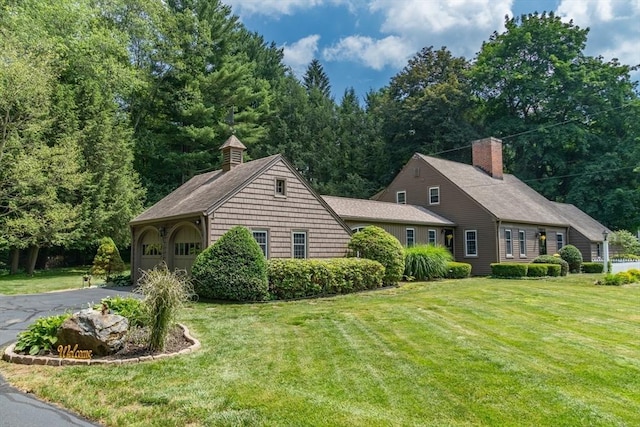 188 Main St, Wilbraham, MA 01095 - view of front of house featuring a front lawn, a chimney, and asphalt driveway