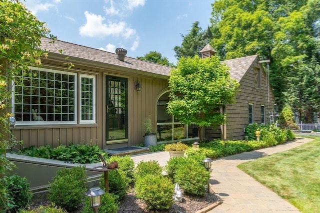 188 Main St, Wilbraham, MA 01095 - view of exterior entry with a shingled roof and board and batten siding