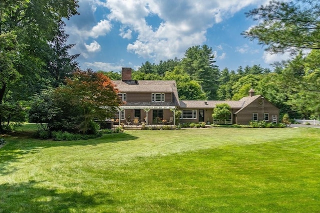188 Main St, Wilbraham, MA 01095 - rear view of property with a chimney and a yard