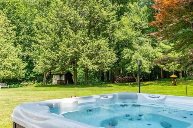 188 Main St, Wilbraham, MA 01095 - view of pool with a hot tub, a yard, an outdoor structure, and a forest view