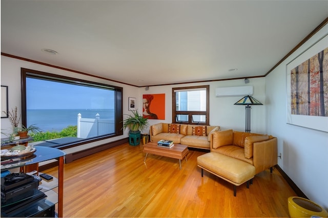 living room featuring an AC wall unit, a water view, hardwood / wood-style flooring, and ornamental molding