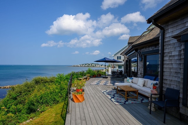 wooden deck featuring an outdoor hangout area and a water view