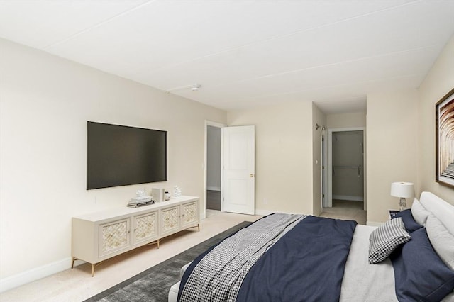 bedroom with light carpet and baseboards