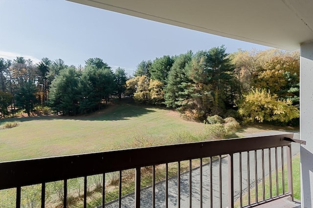 balcony featuring view of scattered trees
