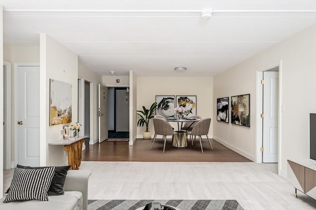 living room featuring baseboards and wood finished floors