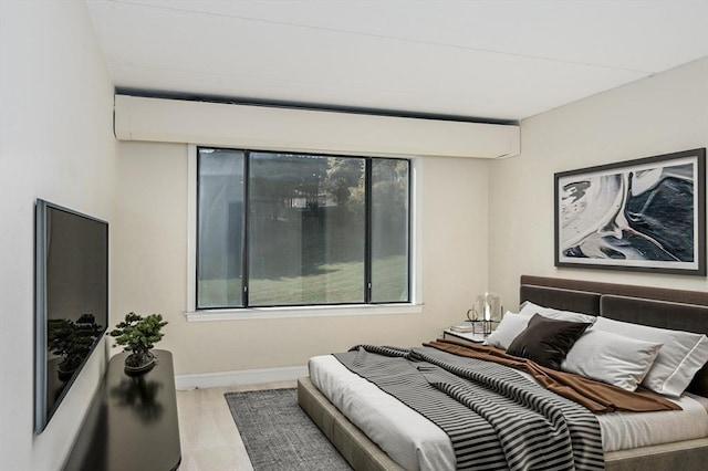 bedroom with baseboards and wood finished floors